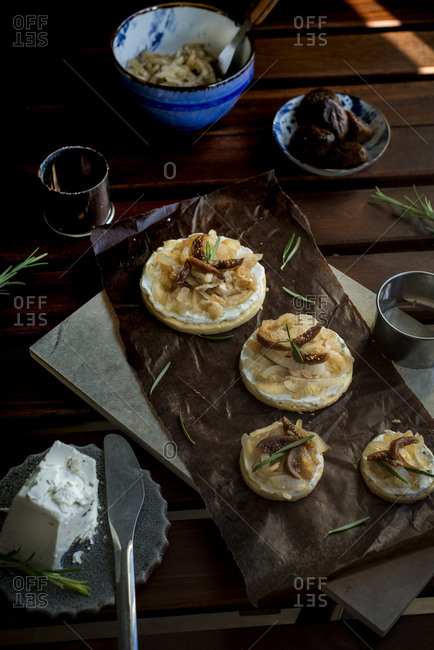 Round salty-sweet onion toast topped with goal cheese and dried fig