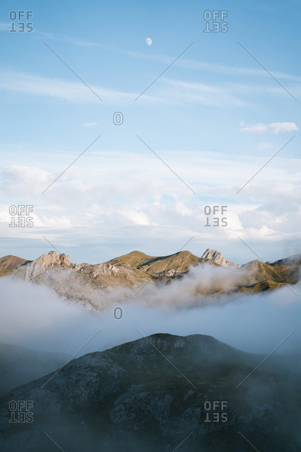 Cloud inversion in high altitude mountains during golden hour in Pyrenees