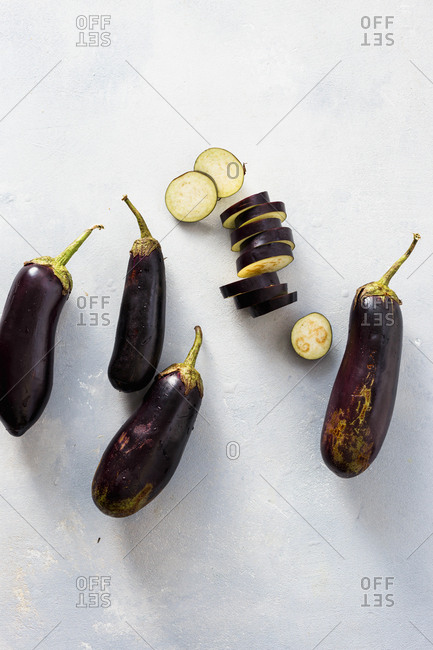 Overhead view of sliced and whole eggplants