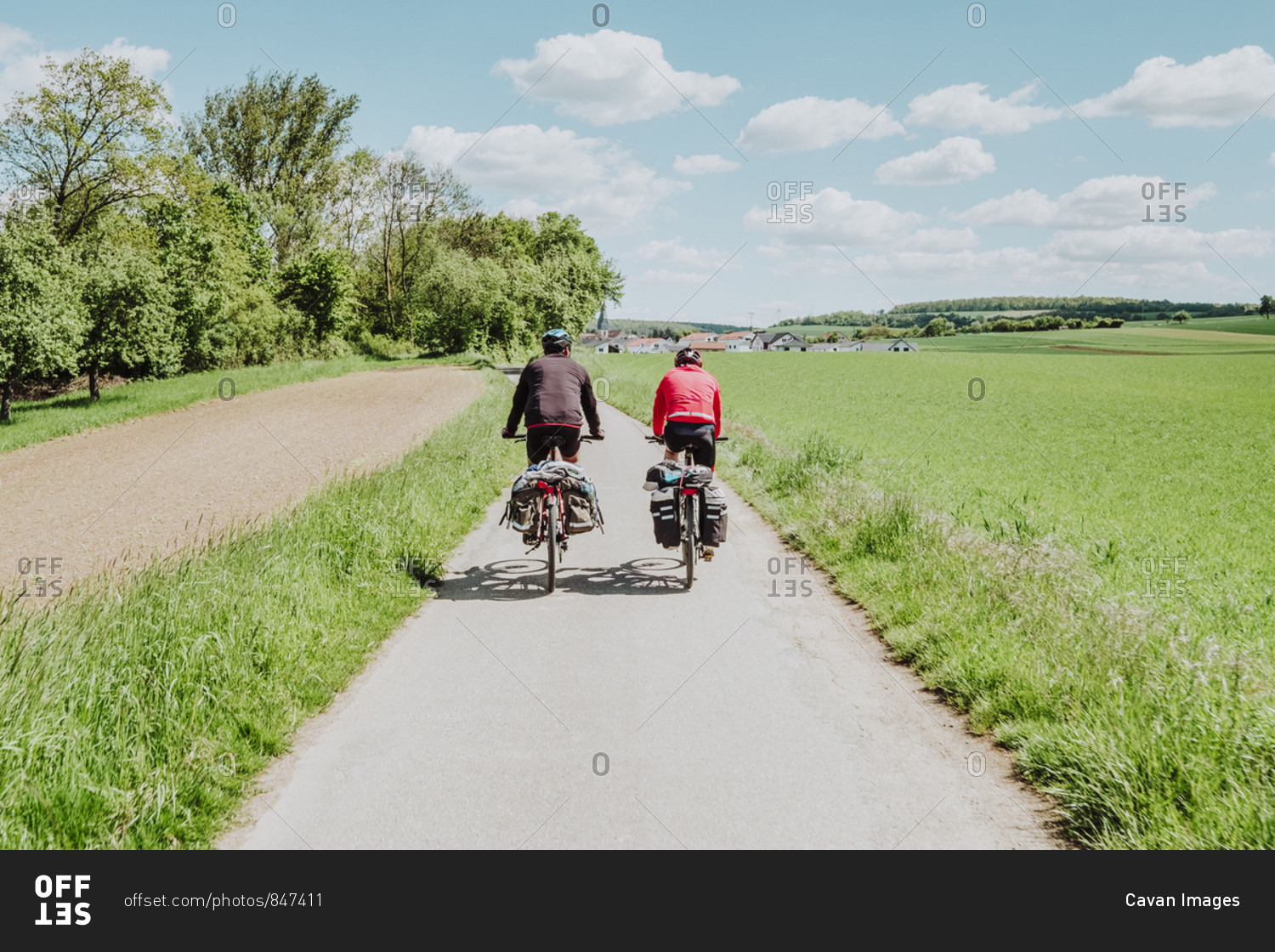 Two cyclists riding his bikes in a bike line, Germany