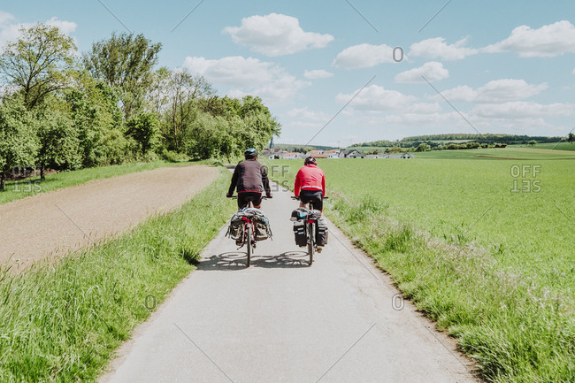 Two cyclists riding his bikes in a bike line, Germany