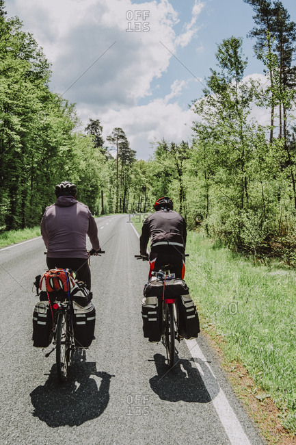 Cyclists riding bikes in the forest, Germany