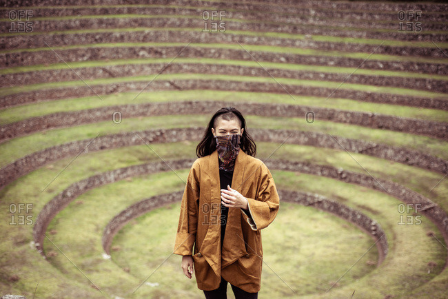 androgynous ninja stands in center of ancient Inca stone circles