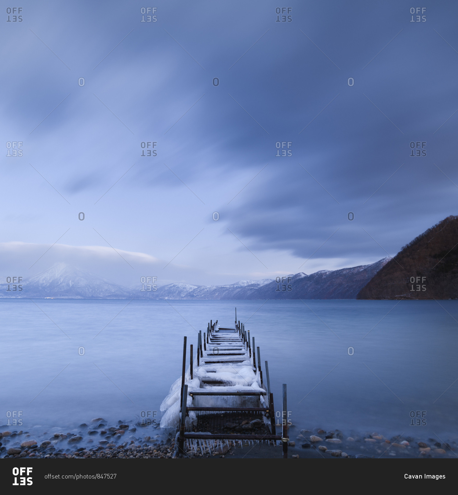Long exposure shot of boat pier covered in ice at Lake Shikotsu, Hokkaido, japan