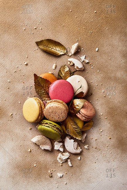 Macarons with golden leaves on a golden sprayed background