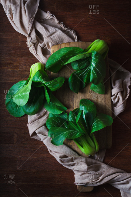 Fresh baby bok choy on a wooden background