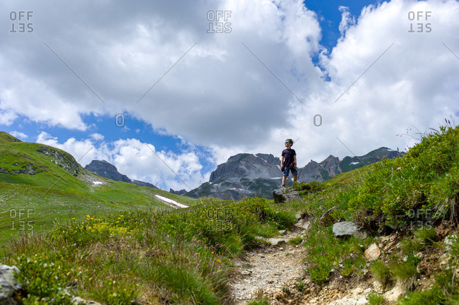 Proud young boy on a mountain trek in northern Europe on a beautiful summer day