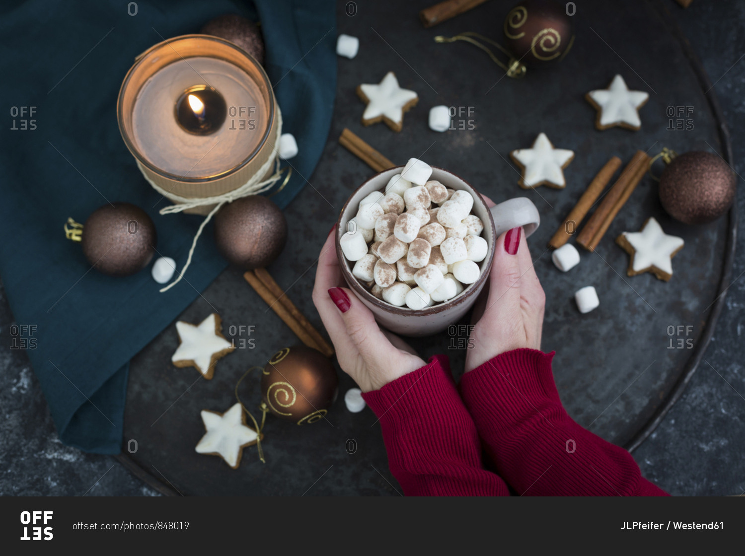 Woman's hands holding cup of Hot Chocolate with marshmallows at Christmas time