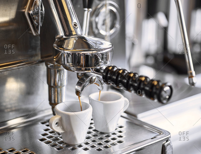 barista holding tamper above portafilter with grinded coffee, espresso, manual  press, arabica Stock Photo by LightFieldStudios