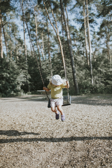 Girl on swing on a playground