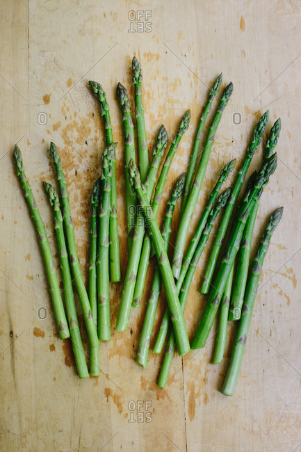 Bunch of fresh cut garden asparagus on a wooden cutting board
