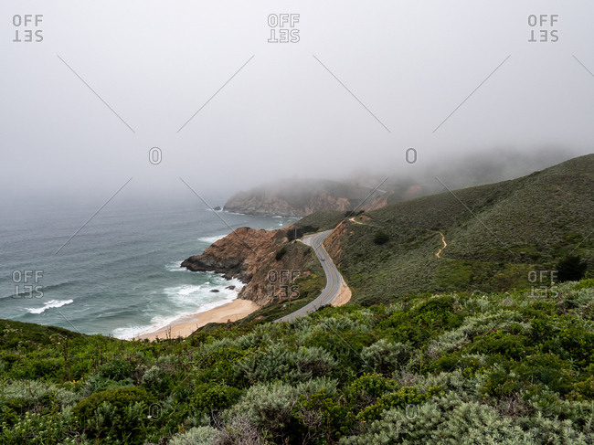 Distant view of coastal highway on foggy day