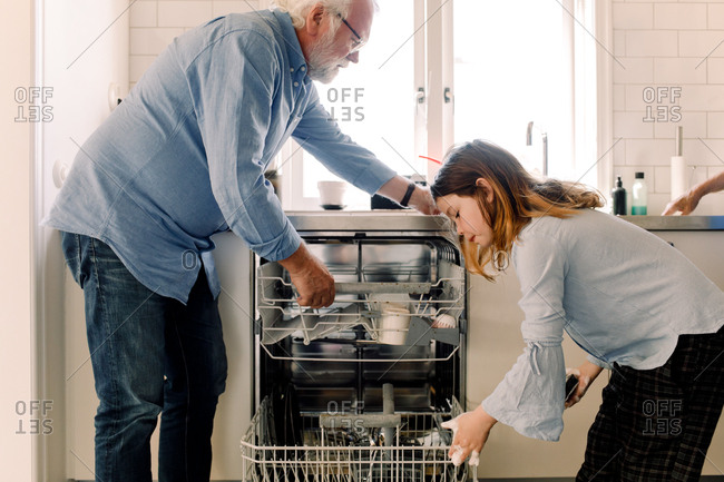 man cleaning kitchen counter stock photos - OFFSET