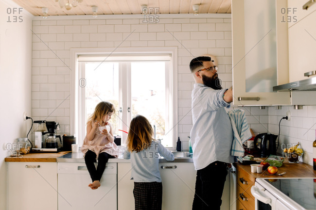 man cleaning kitchen counter stock photos - OFFSET