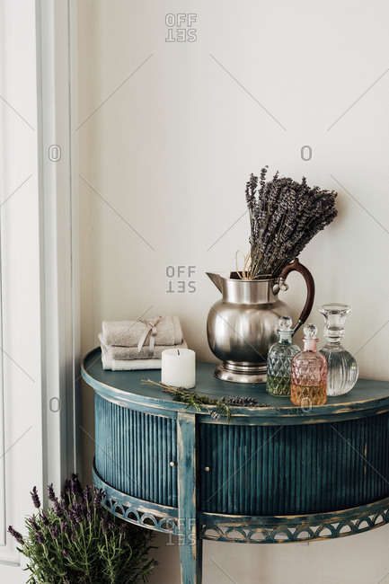 Crystal decorative bottles on rustic table at wellness salon.