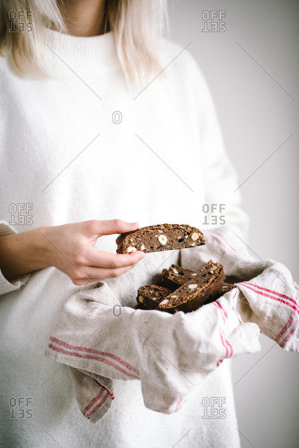 Woman holding biscotti in a towel