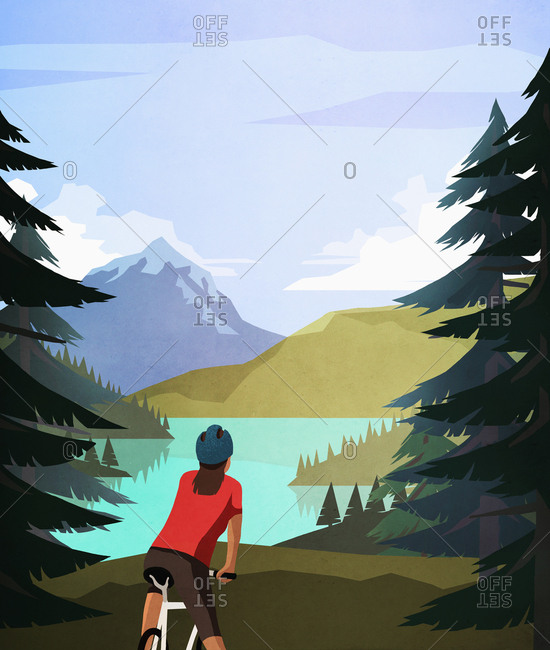 Female mountain biker looking at idyllic, tranquil mountain lake view
