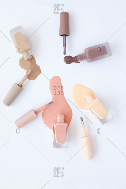 Overhead view of neutral color nail polish on a white backdrop