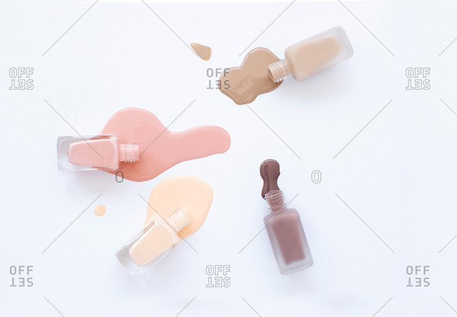 Overhead view of neutral color nail polish on a white backdrop