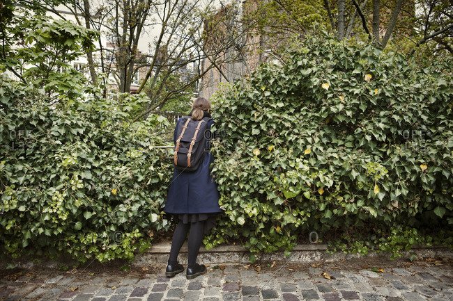 Woman by shrubs