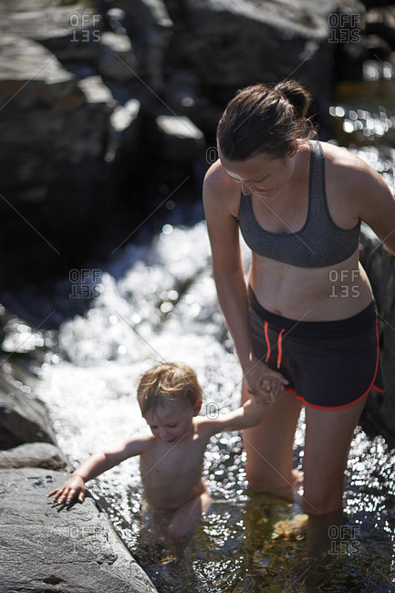 Mother with boy in stream