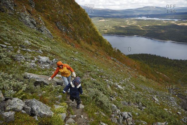 Grandmother and grandson hiking on mountain