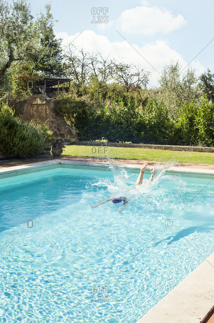 Woman diving into swimming pool