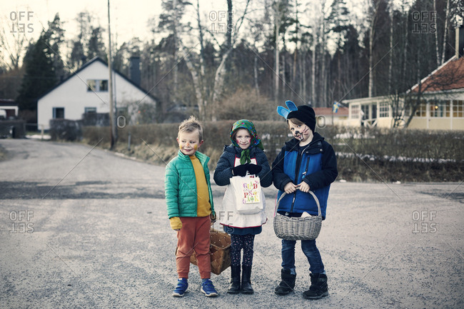 Children in Halloween costumes on road