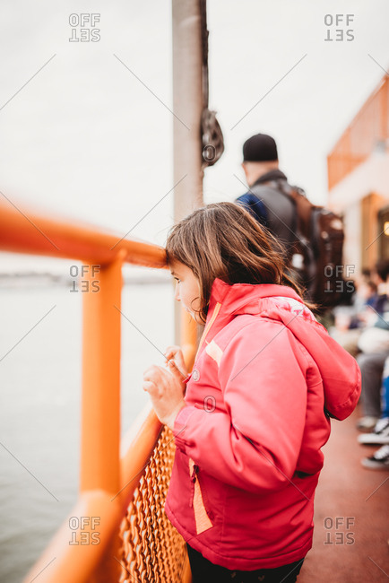 Girl on ferry looks out onto the water