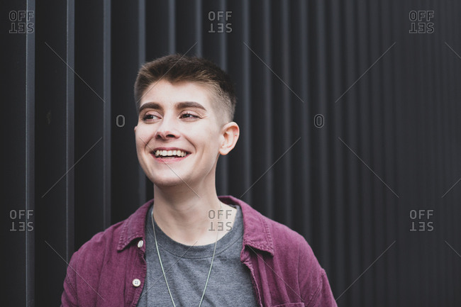 Gender neutral young adult walking down street