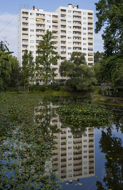 Berlin, Germany - August 27, 2019: Reflection of an apartment building reflected in a lily pond.