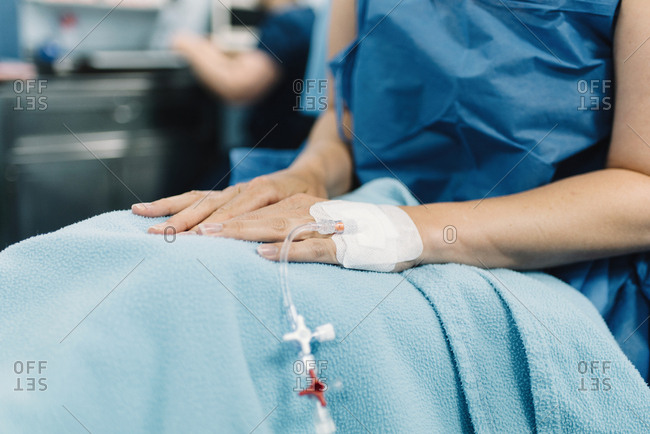 An IV bag hanging in a hospital room stock photo - OFFSET