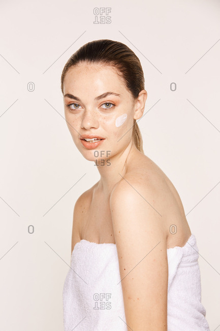 Amiable female taking care of face