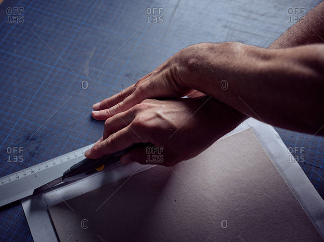 Craftsmanship cutting cardboard with paper knife