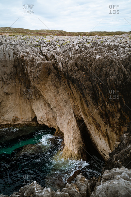 Natural caves at the bottom of the cliffs on the coast of Asturias