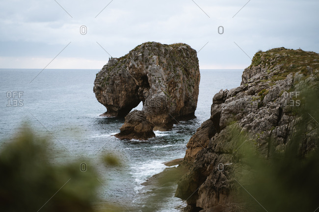 Big rock formation in rugged coast of Asturias in Spain