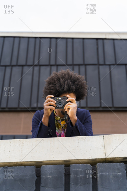 Stylish man taking a picture with a camera