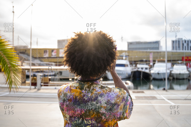 Rear view of man with a camera wearing colorful shirt