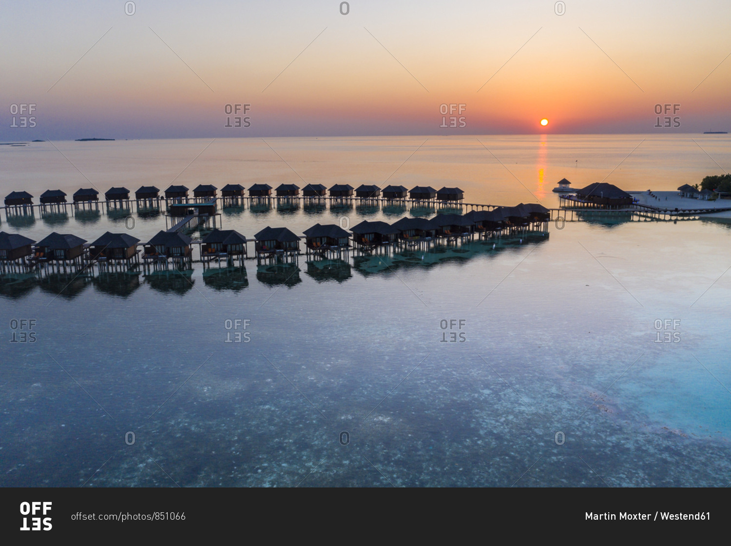 Maldives- Olhuveli island- Resort bungalows on South Male Atoll lagoon at sunset