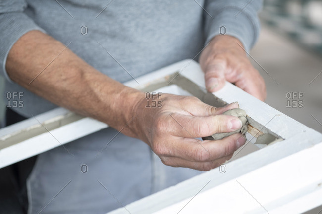 Glazing, glazier during work, cutting glass with glass cutter