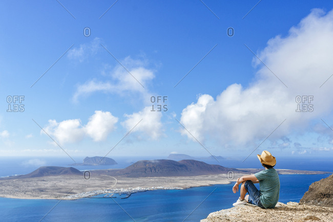 Man on viewpoint looking to La Gracioas island from Lanzarote- Canary Islands- Spain