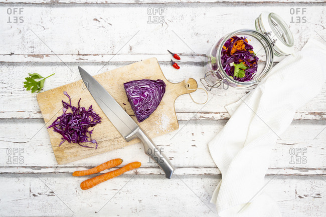 Red cabbage- chili peppers- carrots and coriander on wooden table