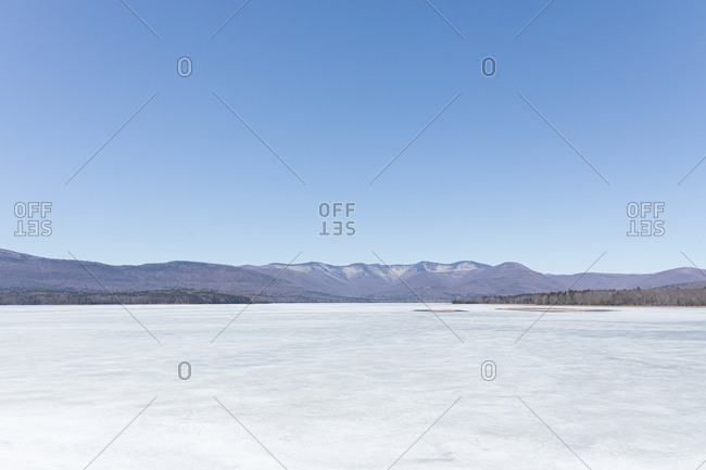 Scenic view of frozen ice on Ashokan Reservoir against clear blue sky