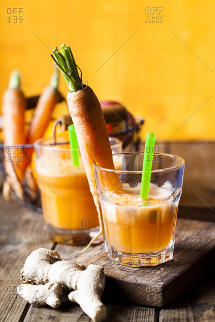 Glass of freshly squeezedĘapple-orange-carrotĘjuice with ginger