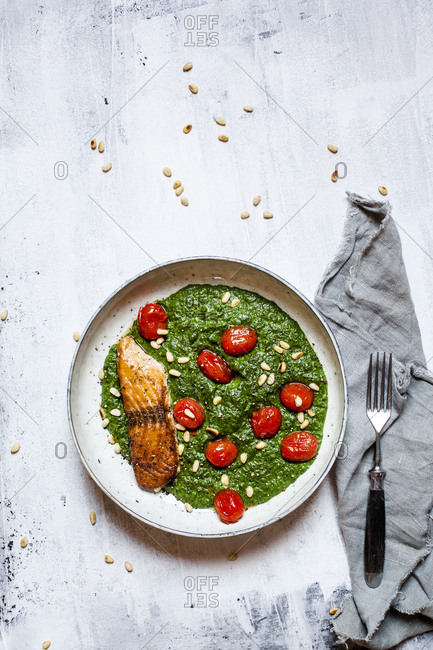 Directly above view of fresh meal in bowl by napkin and fork on white table
