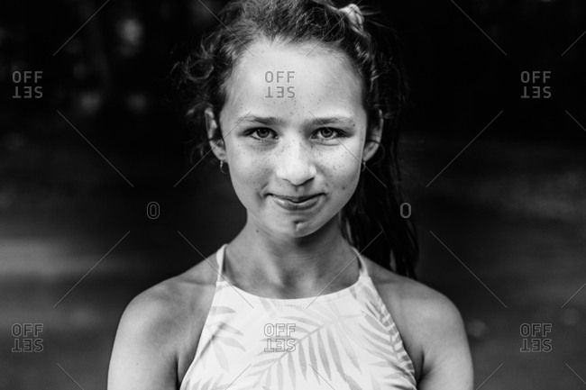 Black and white portrait of young girl outside in summertime