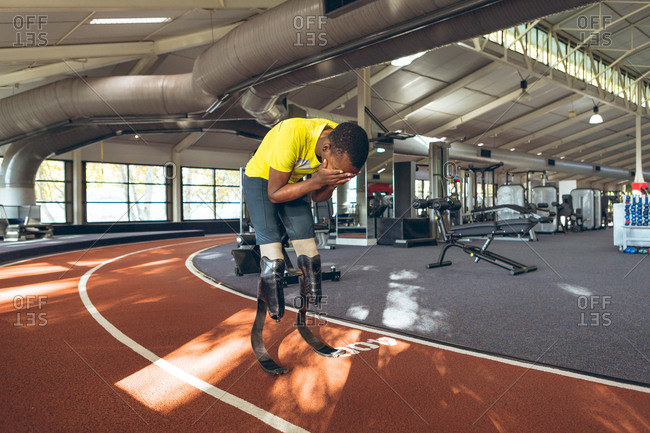 Disabled African American male athletic disappointed after losing race in fitness center