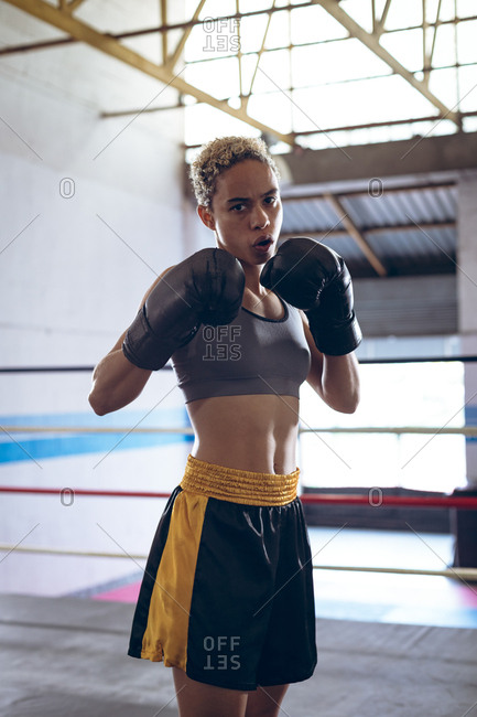 Female boxer practicing boxing in boxing club