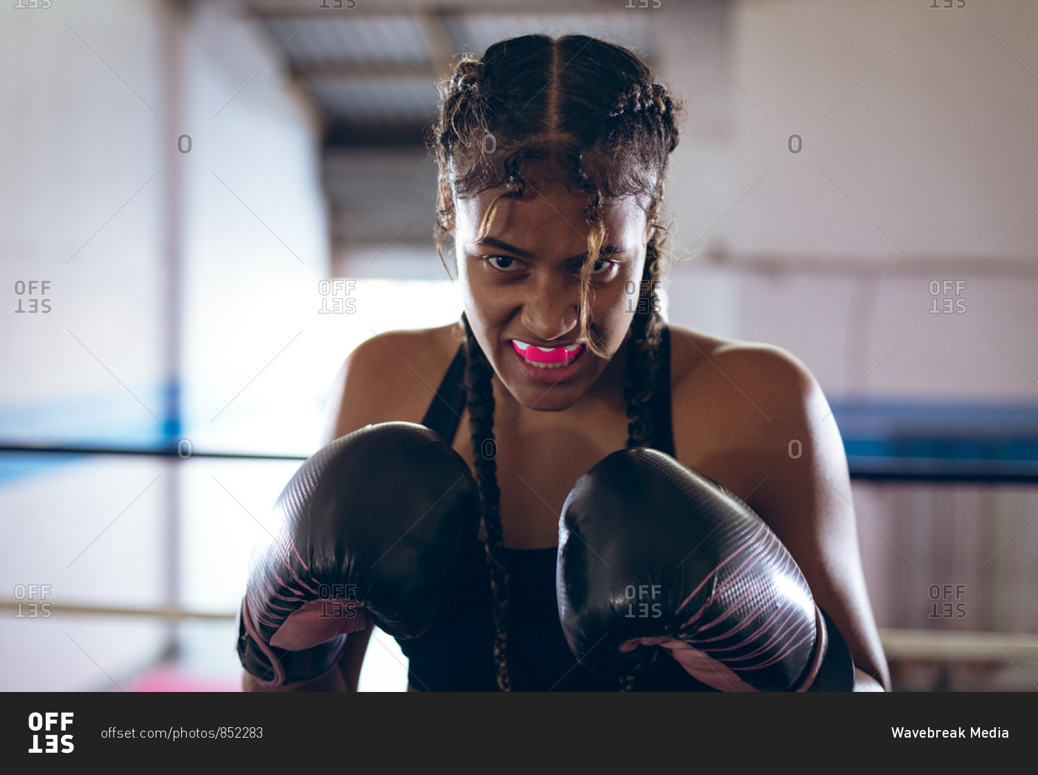 Female boxer practicing boxing in boxing club
