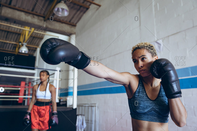 Female boxer practicing boxing in boxing club